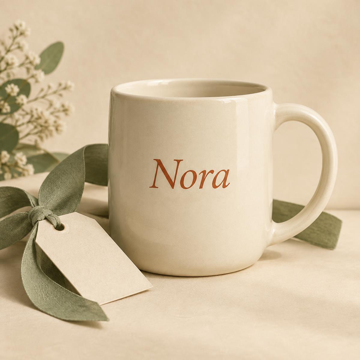 Cream ceramic mug personalized with the name Nora